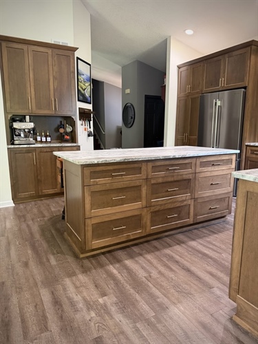 Remodeled Loretto kitchen with large island, custom wood cabinetry and built-in refrigerator storage