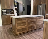 Remodeled Loretto kitchen with large island, custom wood cabinetry and built-in refrigerator storage